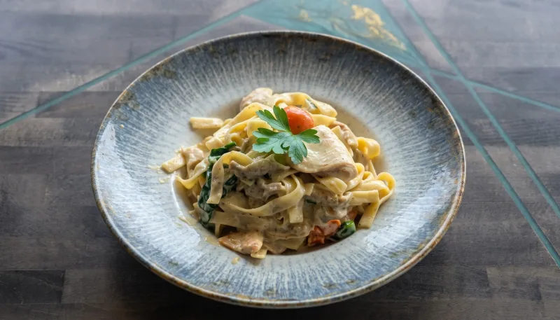 Alma Verde — Tagliatelle, Pesto-Sahnesosse, Hähnchen, Cherrytomaten und Babyspinat bei Kaspio in Stade
